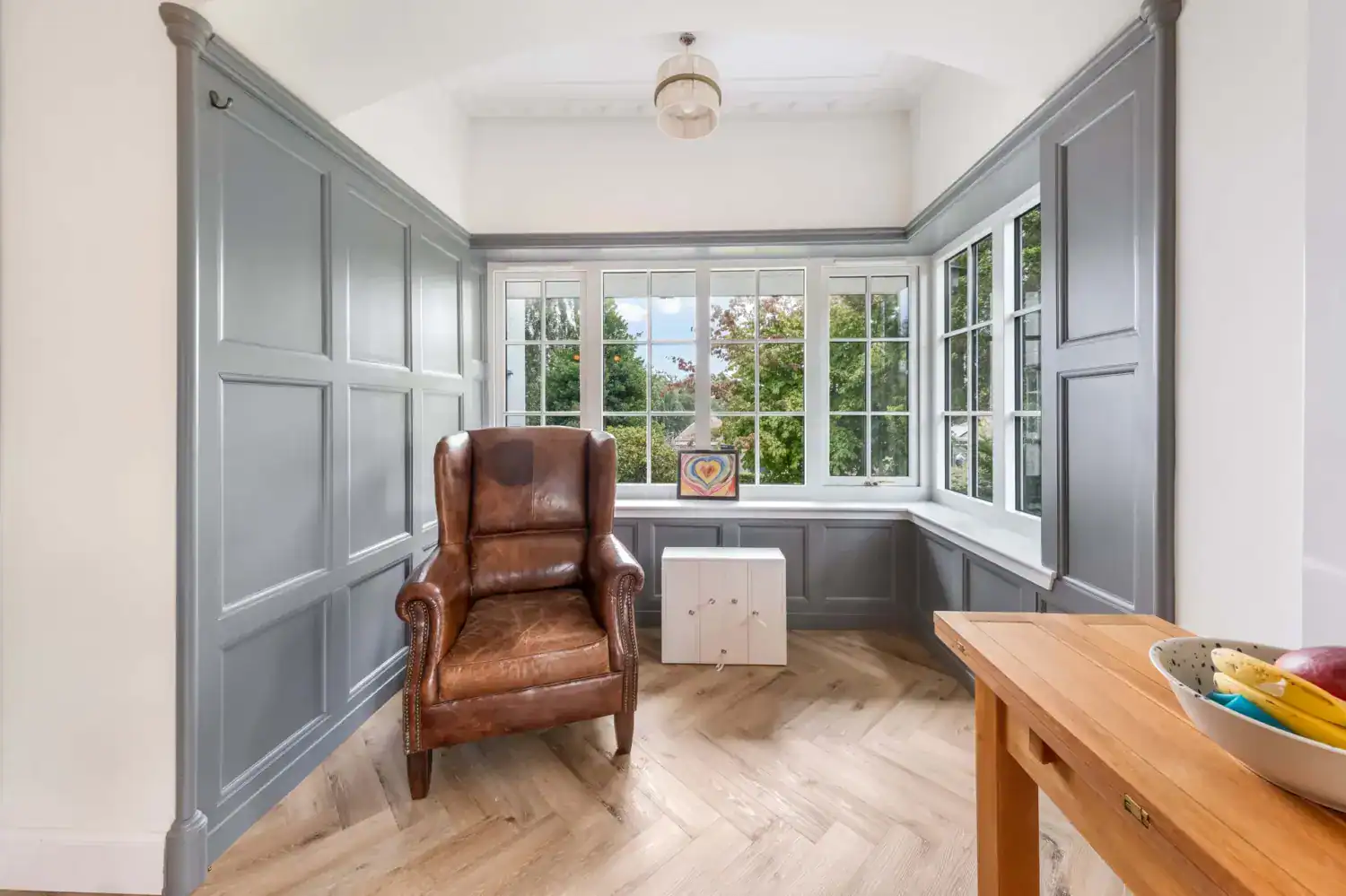 Window seating area with grey panelling at Hazel Drive