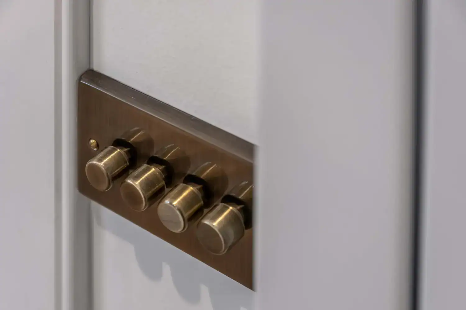 Brass switches in a grey wall plate at Hazel Drive