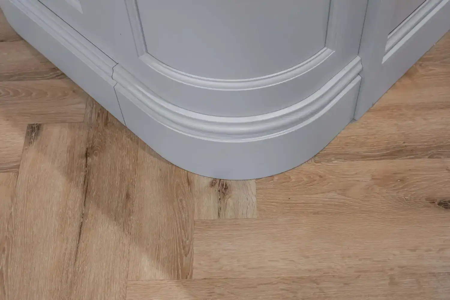 Curved island cabinetry and timber flooring at Hazel Drive